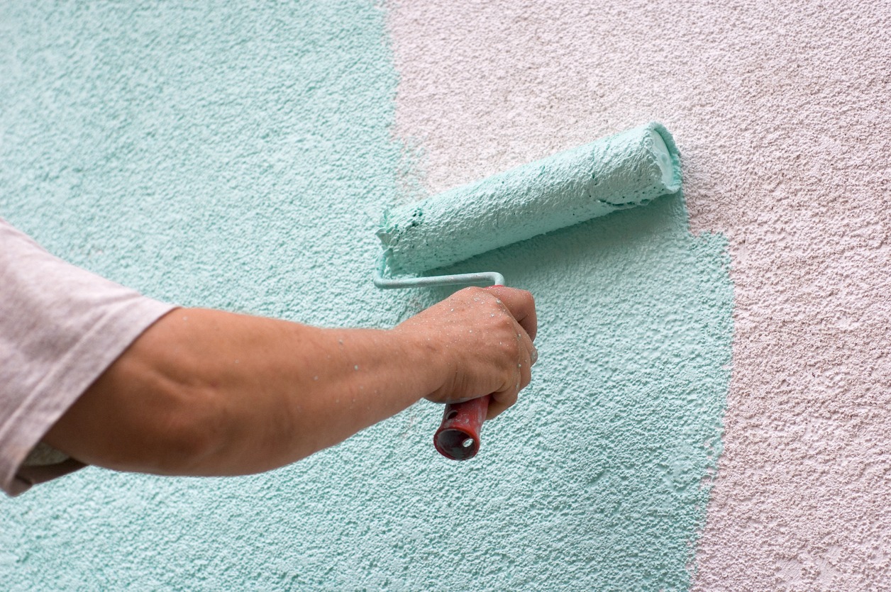 worker painting a white wall