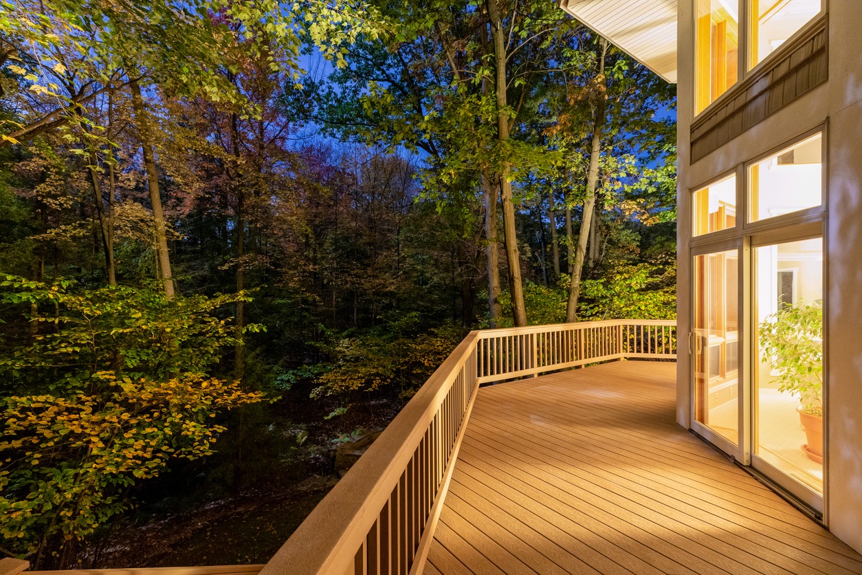 Large composite deck on a luxury home in the woods