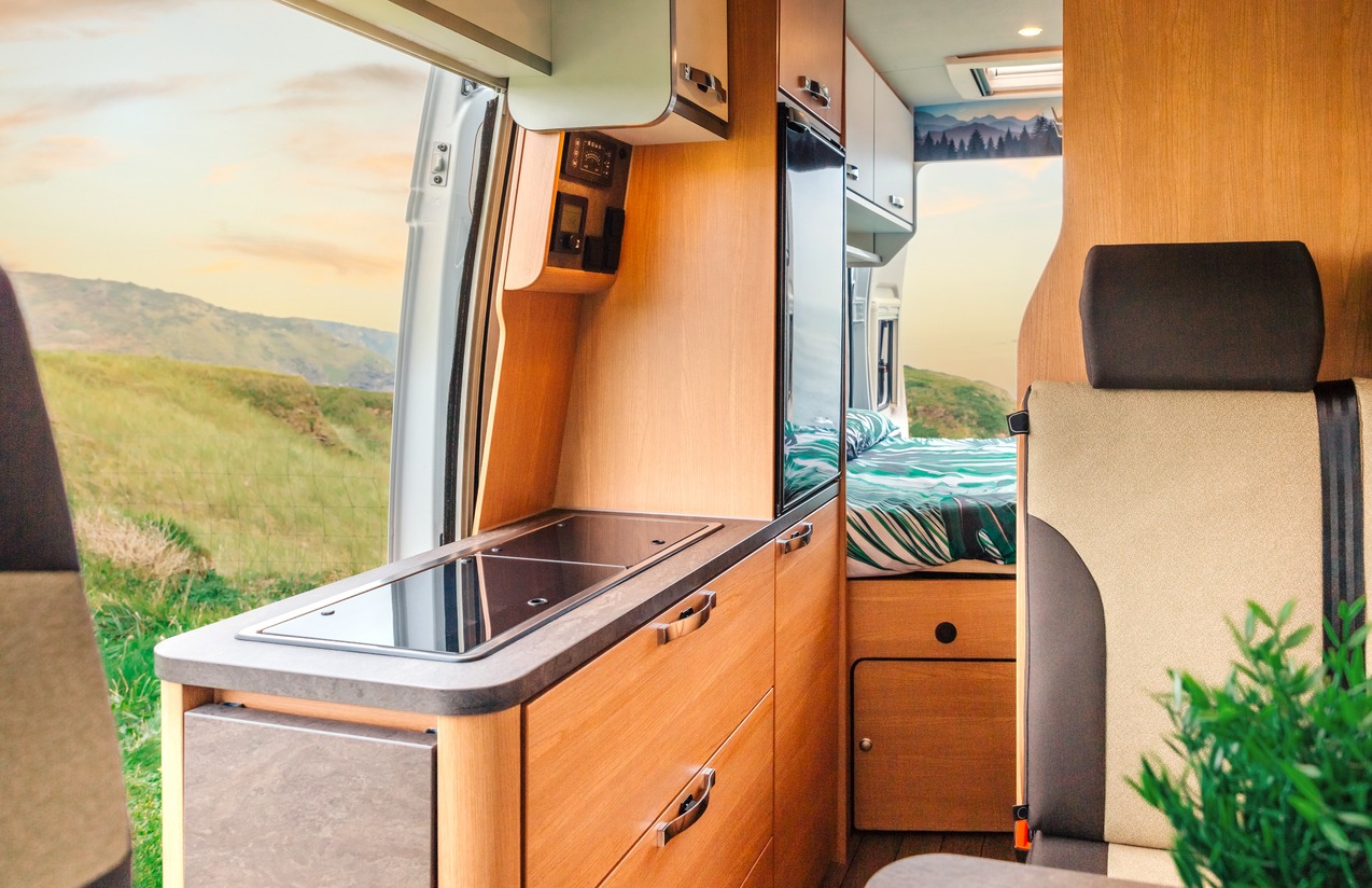 Interior of a camper van with kitchen and bed